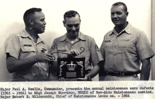 Major Robert E. Wildermuth, Chief of Maintenance, looks on as Major Paul A. Hamlin presents a maintenance award, 1966.
