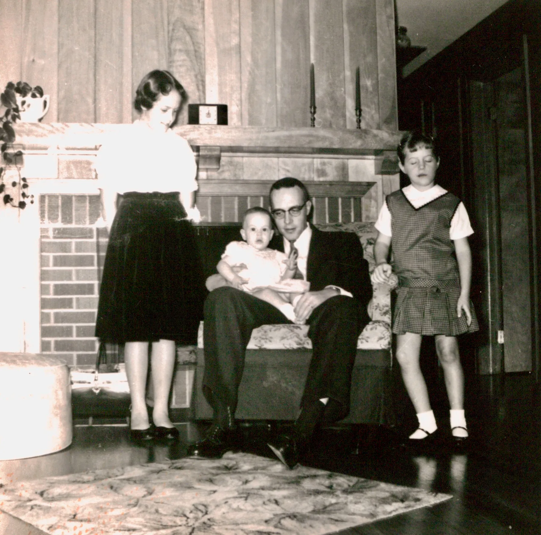 Norm Wolfe with his three daughters at the Hillcrest fireplace — c. 1960