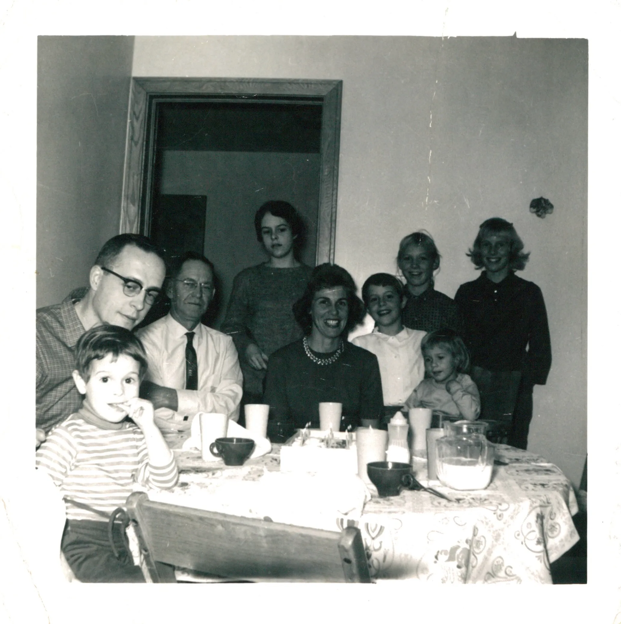 Dottie at a birthday table with Uncle Norm Wolfe and family, c. late 1950s–early 1960s. Aunt Maggie deck.