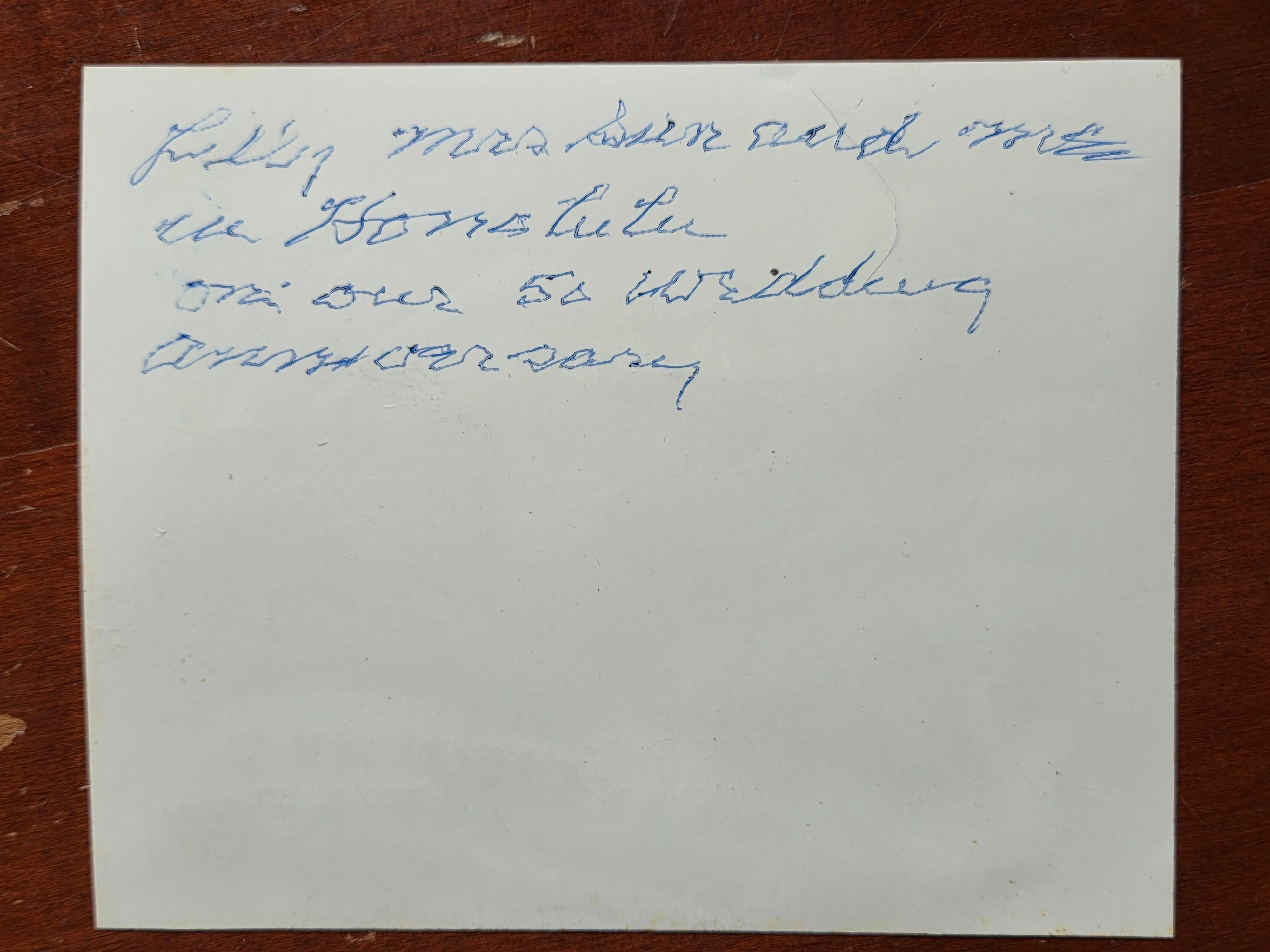 The back of the same photograph, inscribed by hand — a note recording that it was taken in Honolulu on their 50th wedding anniversary.