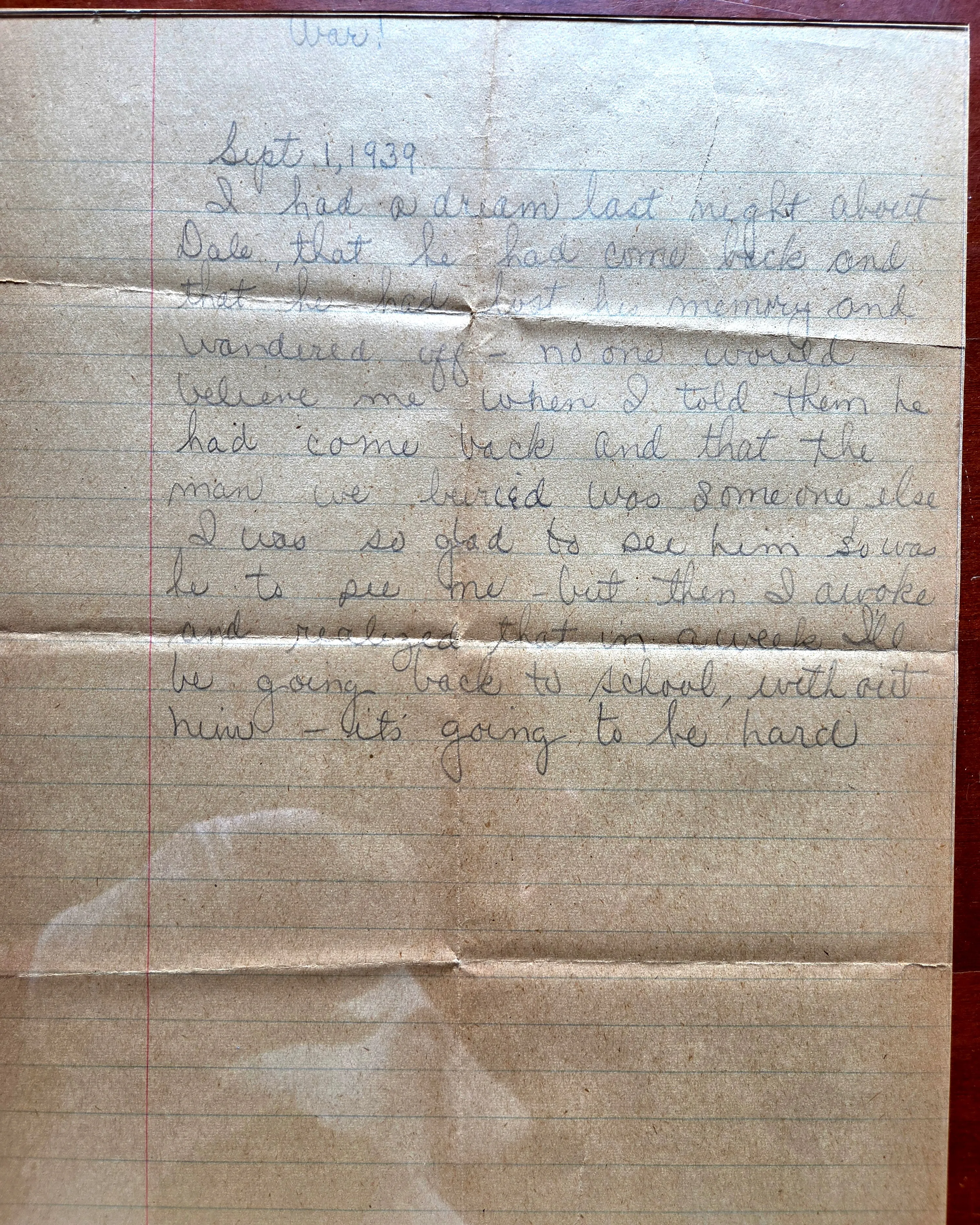 Handwritten one-page journal entry on yellowed lined paper, dated 'Sept. 1, 1939' in a fifteen-year-old's careful hand. At the very top of the page, inverted relative to the main text, is the single word 'War!' written across the top edge. Below it, the dream-of-Dale entry. Pencil. The paper carries deep fold and crease wear from sixty-plus years of keeping.