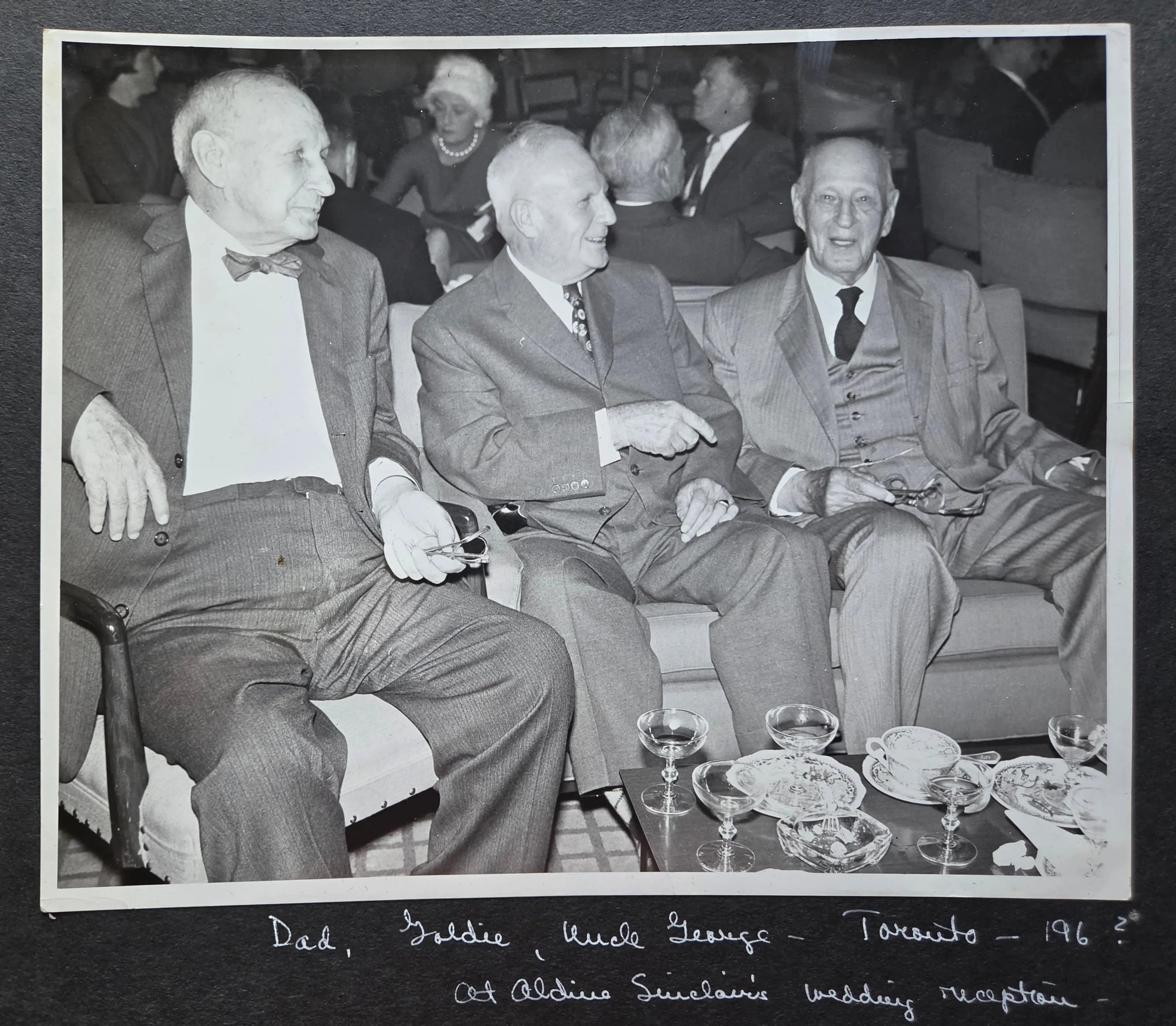 Charles Leonard Eesley (left) with his brothers "Goldie" (center) and Uncle George Henry Eesley (right) at Aldine Sinclair's wedding reception, Toronto, c. mid-1960s. From Roberta Burnes Walker's family album. Label written by Helen Burnes (Charles Leonard's daughter), whose "Dad" identifies him.