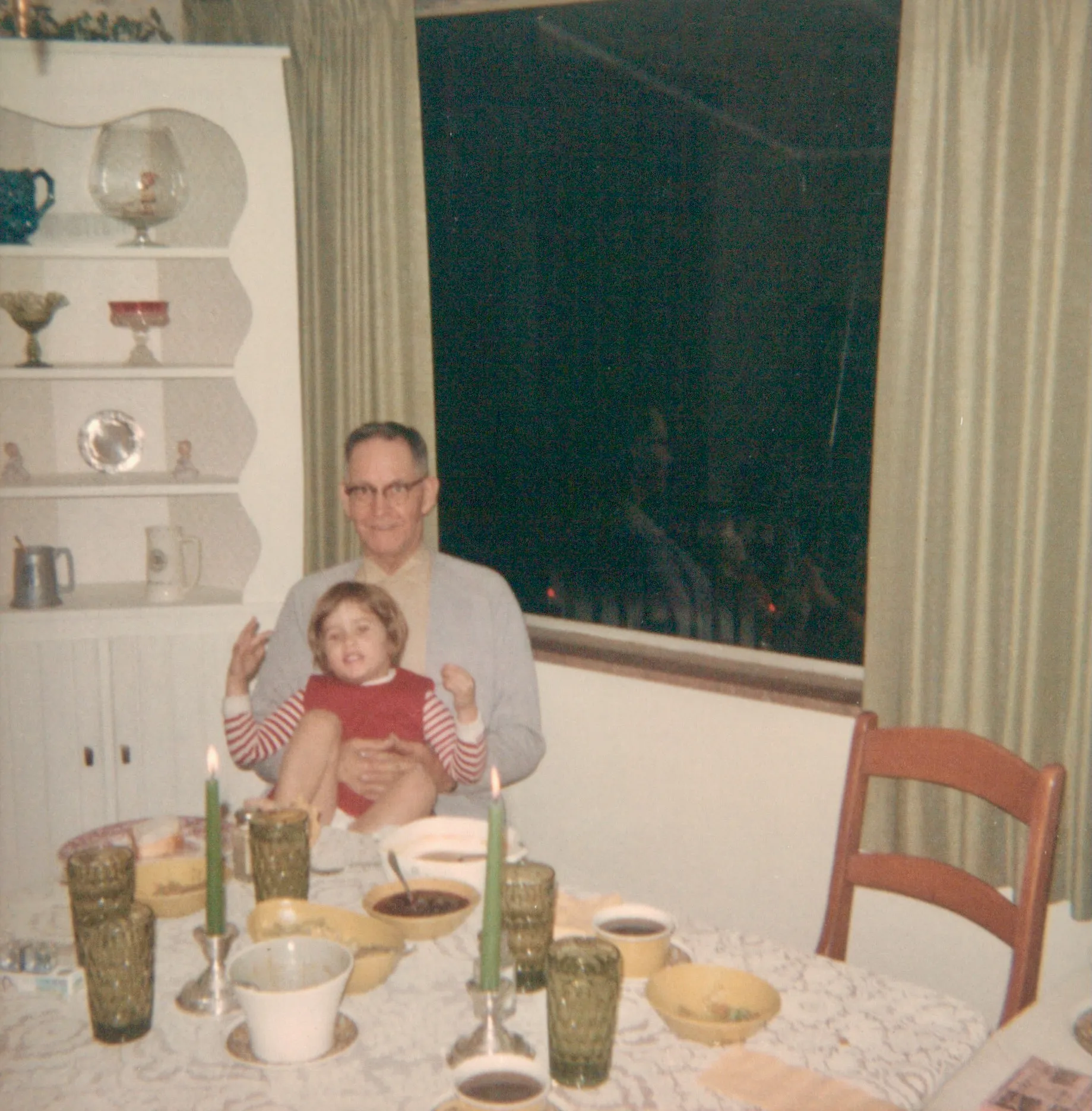 Homer Davis with a young grandchild on his lap at a candlelit Florida dinner table, c. late 1960s or early 1970s. From Chuck's keeping.