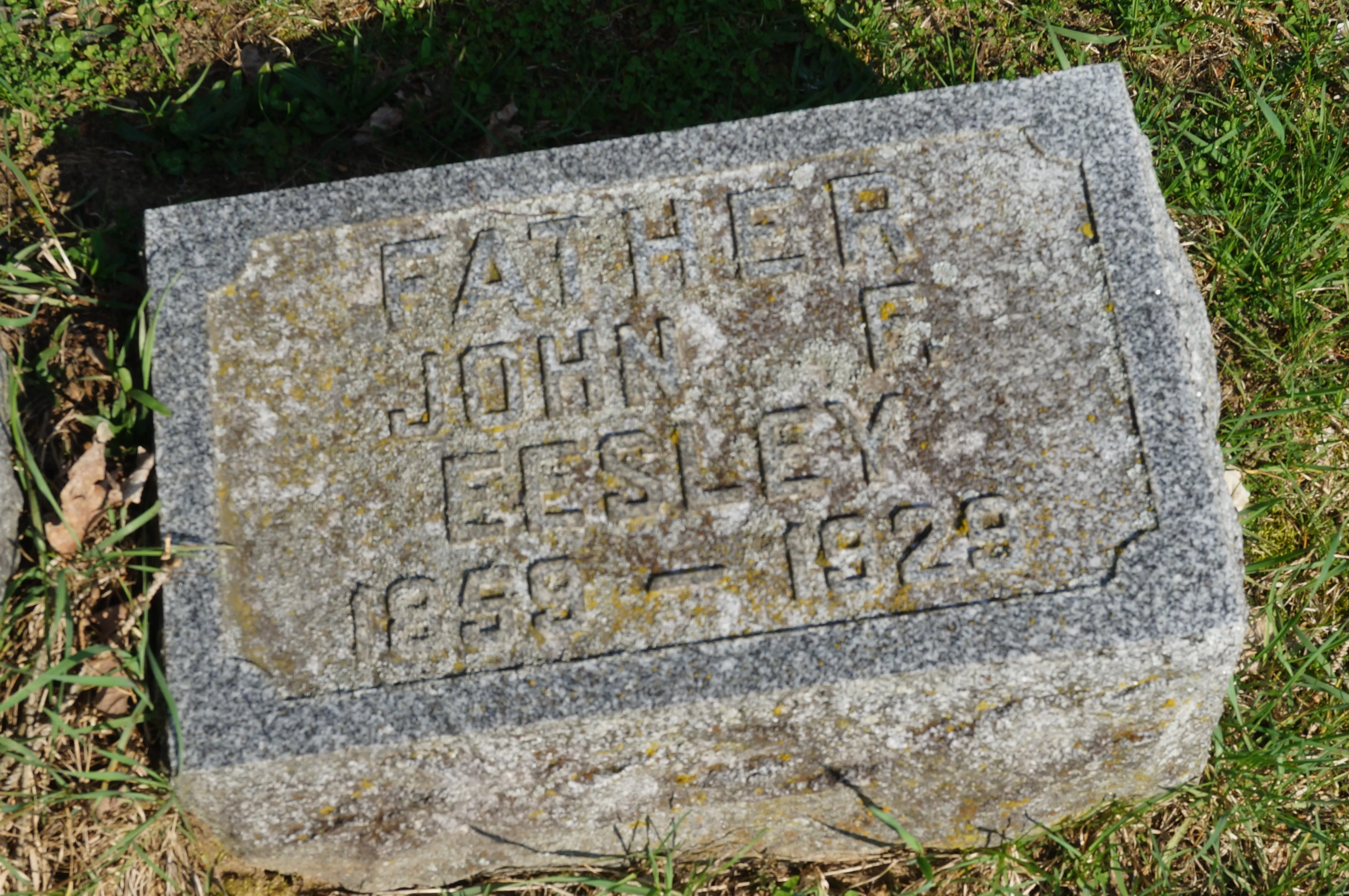 The granite grave marker of John F. Eesley at Hillside Cemetery, Plainwell, Michigan, carved “FATHER / JOHN F. EESLEY.”