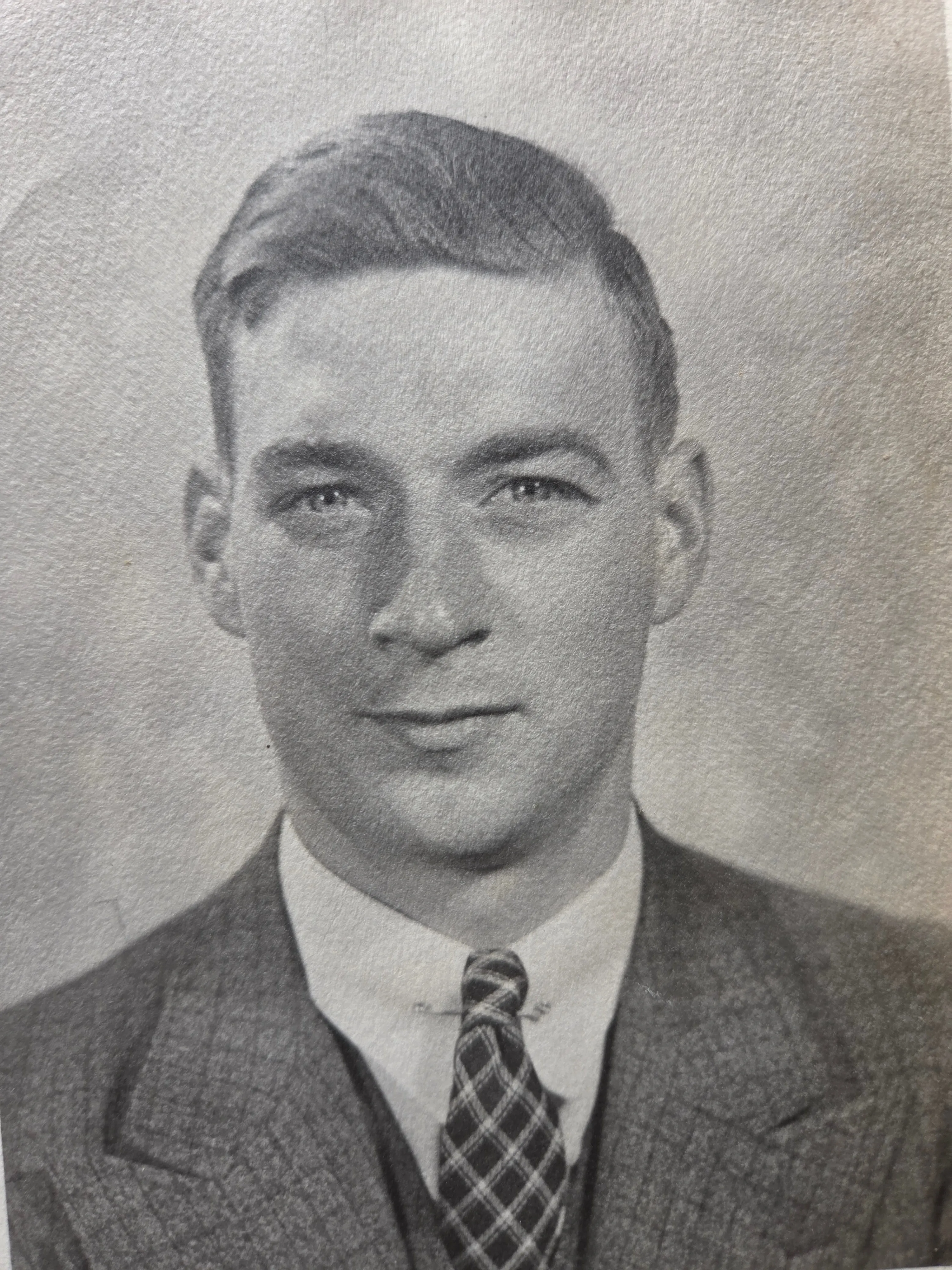 Lyle Eesley as a young man of about eighteen — light hair parted on the side, suit and patterned tie, studio yearbook-style portrait. Likely his Bexley High School senior portrait or an early-Otterbein portrait, c. 1934. From Roberta Burnes's keeping via Helen Eesley Burnes.