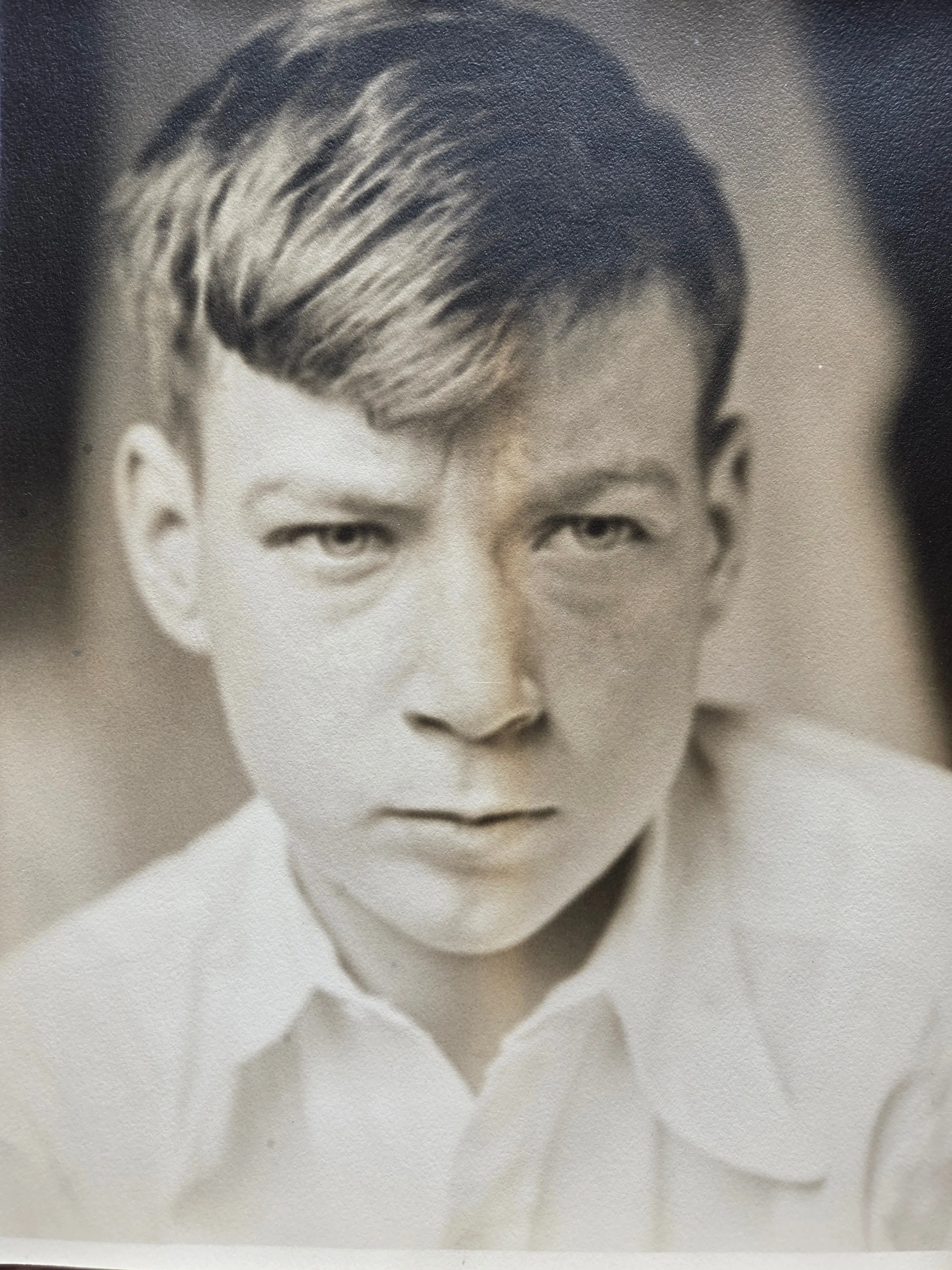 Lyle Eesley as a boy of about twelve to fourteen years — fair-haired, intense-eyed, in a collared white shirt. Studio portrait c. 1928-1930. From Roberta Burnes's keeping via Helen Eesley Burnes.