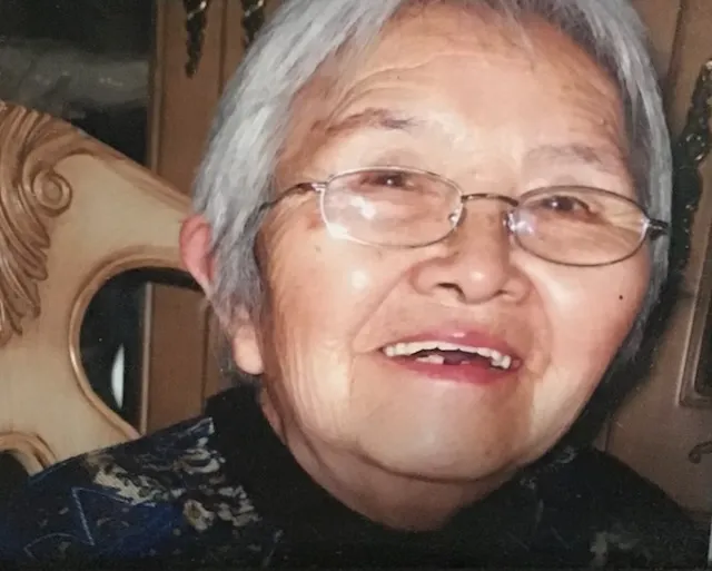 A warm close-up of Shang Yaozhen, smiling, in later life.