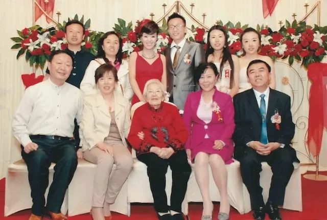 Shang Yaozhen (seated, center) among the family at a wedding.