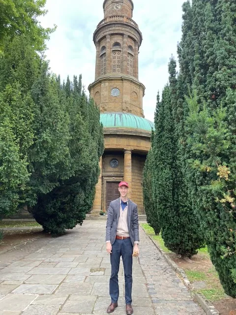 St Mary's Church, Banbury, Oxfordshire — a Georgian church with a distinctive cylindrical rotunda tower, at the end of a yew-lined path; a member of the family stands in front on an Eesley research trip.