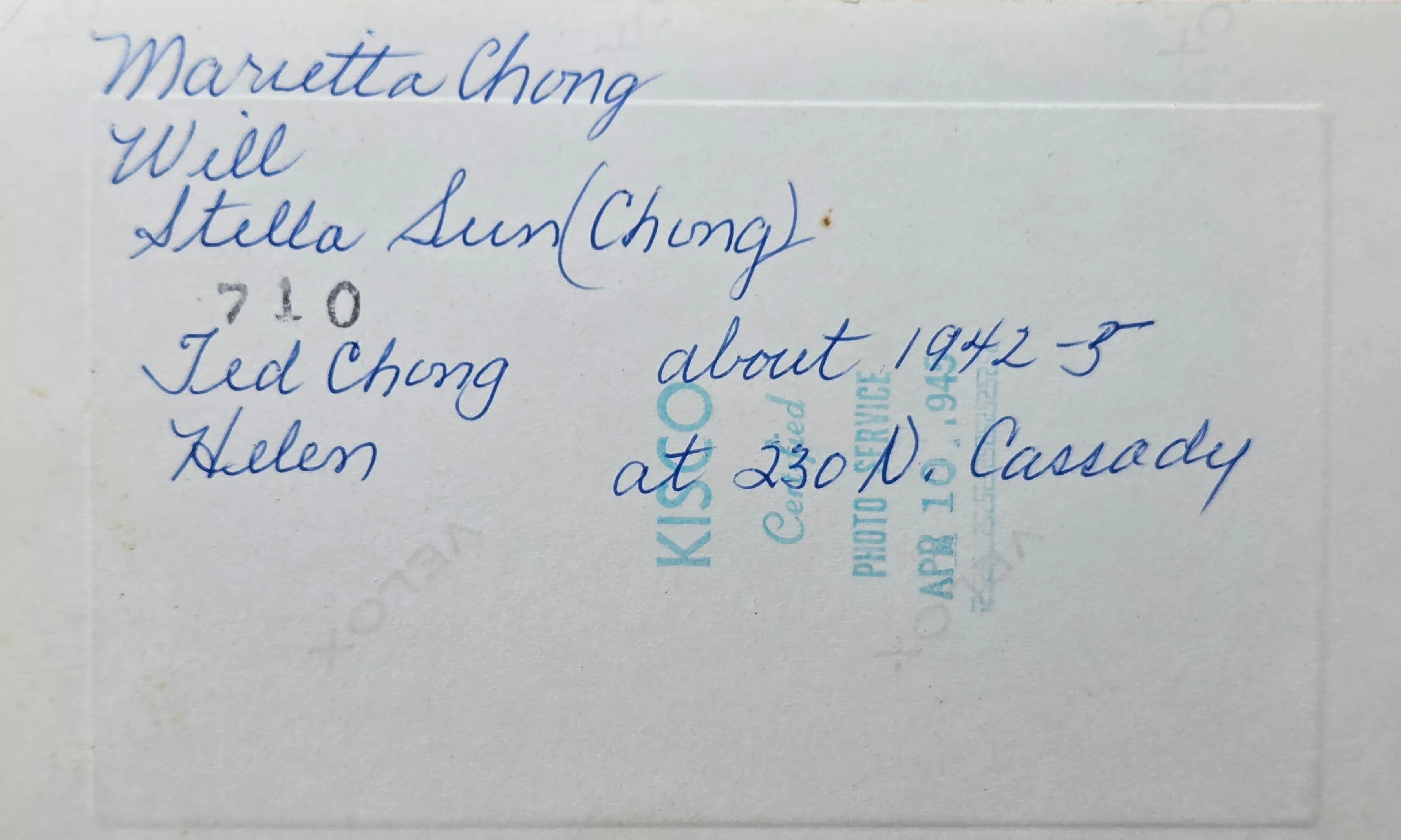 The back of the print — the handwritten blue-ink caption naming all five figures ("Marietta Chong / Will / Stella Sunn (Chong) / Ted Chong / Helen … at 230 N. Cassady") over the KISCO Certified Photo Service stamp dated 10 April 1945.