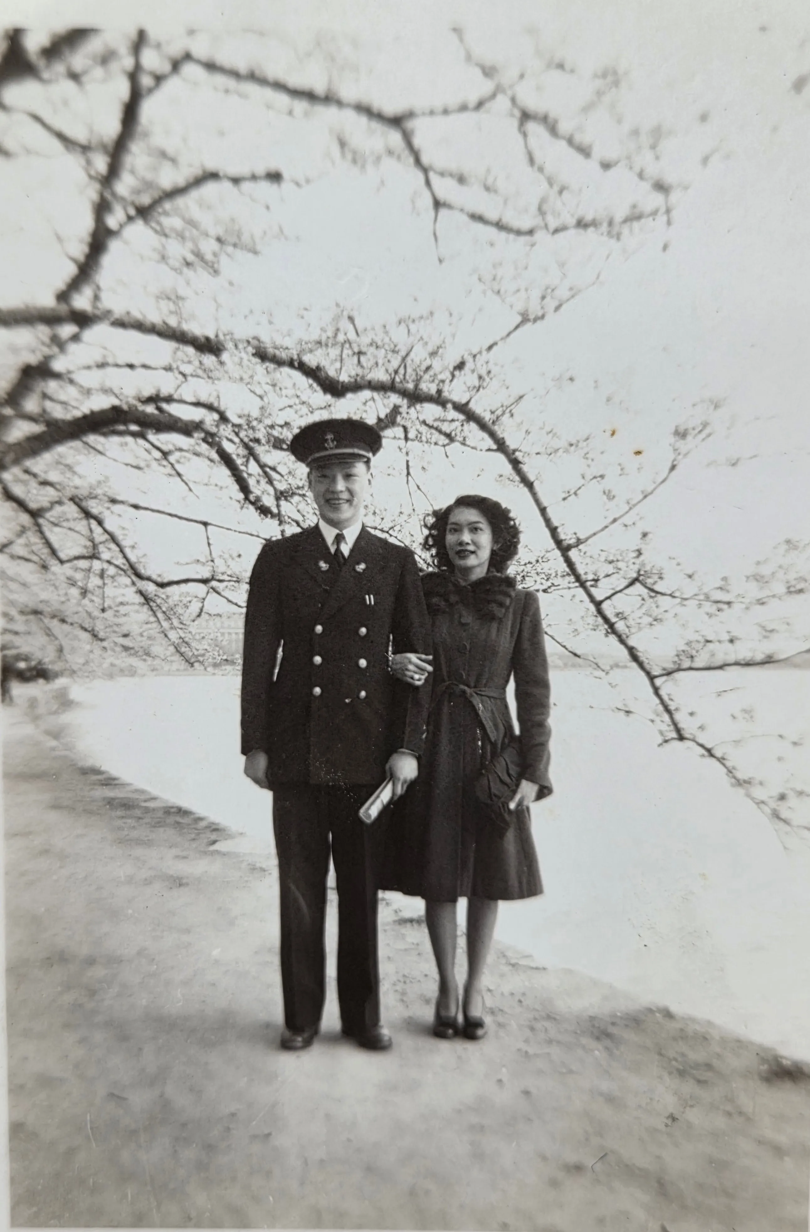 Ted Chong in U.S. Navy dress uniform with Stella at the cherry-blossom-season Tidal Basin in Washington, D.C., dated 10 April 1945 by the photo service stamp on the back.