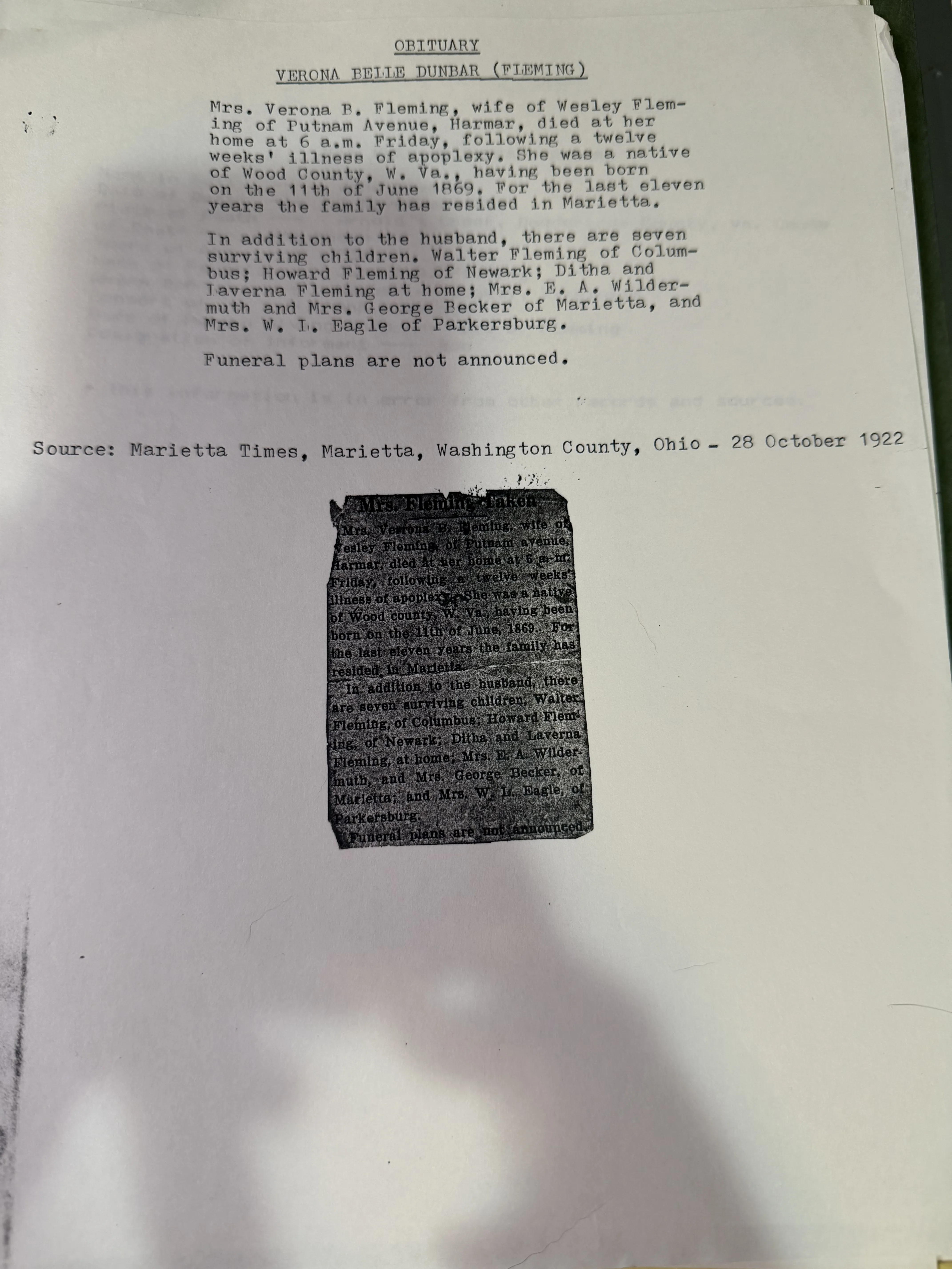 A typed sheet headed OBITUARY, VERONA BELLE DUNBAR (FLEMING), transcribing the notice in full and citing its source as the Marietta Times of 28 October 1922, with the original newspaper clipping pasted below it, headed Mrs. Fleming Taken, its column creased and darkened but legible.