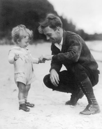 Will Eesley, about twenty-two, crouching on the beach at Black Lake, Michigan to take the hand of his first nephew, Tommy Eesley, c. 1933. From Maggie Eesley's Four Generations deck (ID WCE001); provenance Peggy McMaster Eesley.