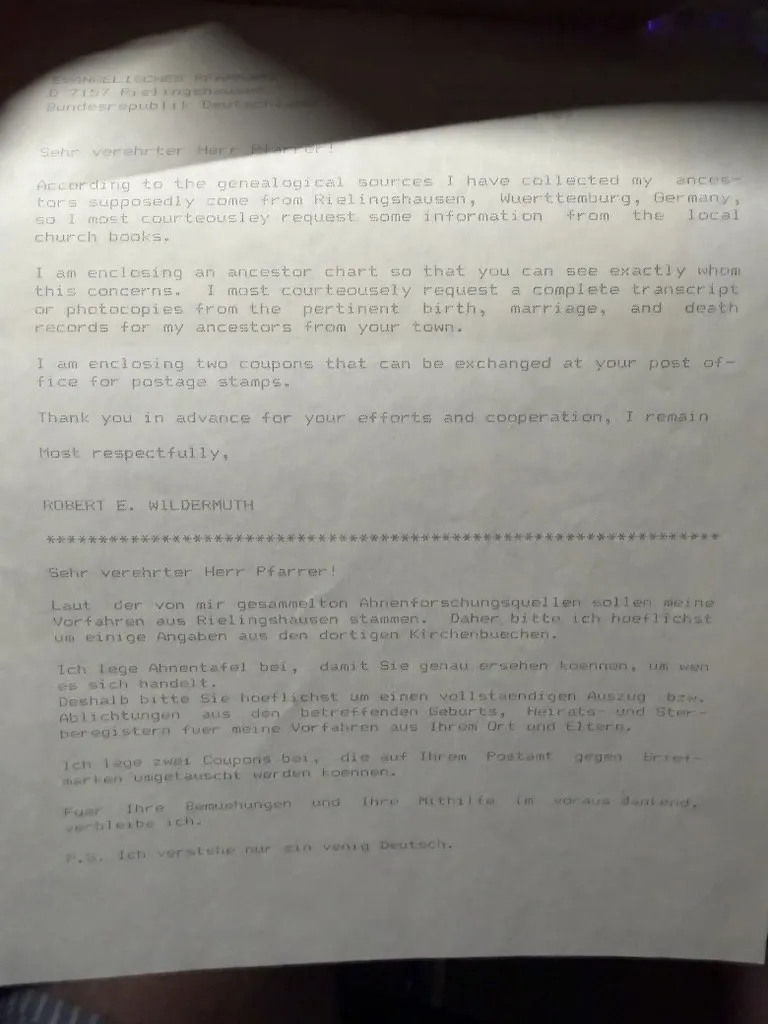A typed form letter addressed to the Evangelisches Pfarramt, D-7157 Rielingshausen, Bundesrepublik Deutschland, written in English in the upper half and repeated in German below, requesting transcripts from the local church books and enclosing an ancestor chart and two international reply coupons, signed Robert E. Wildermuth.