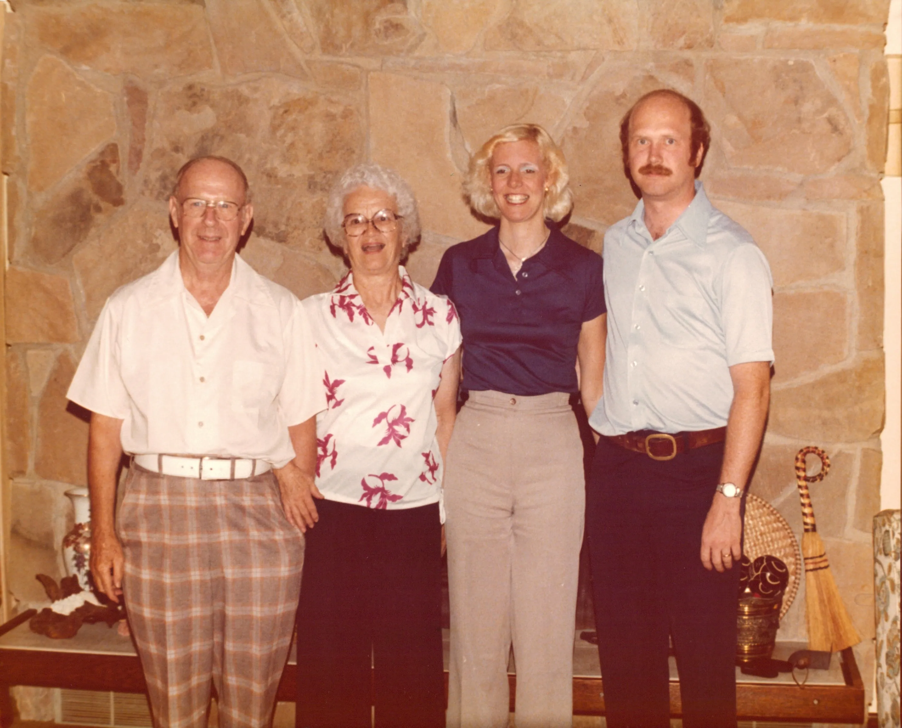 Will, Peggy, Charlie, and Terrie at the Highland Ridge stone fireplace — c. 1978-1982