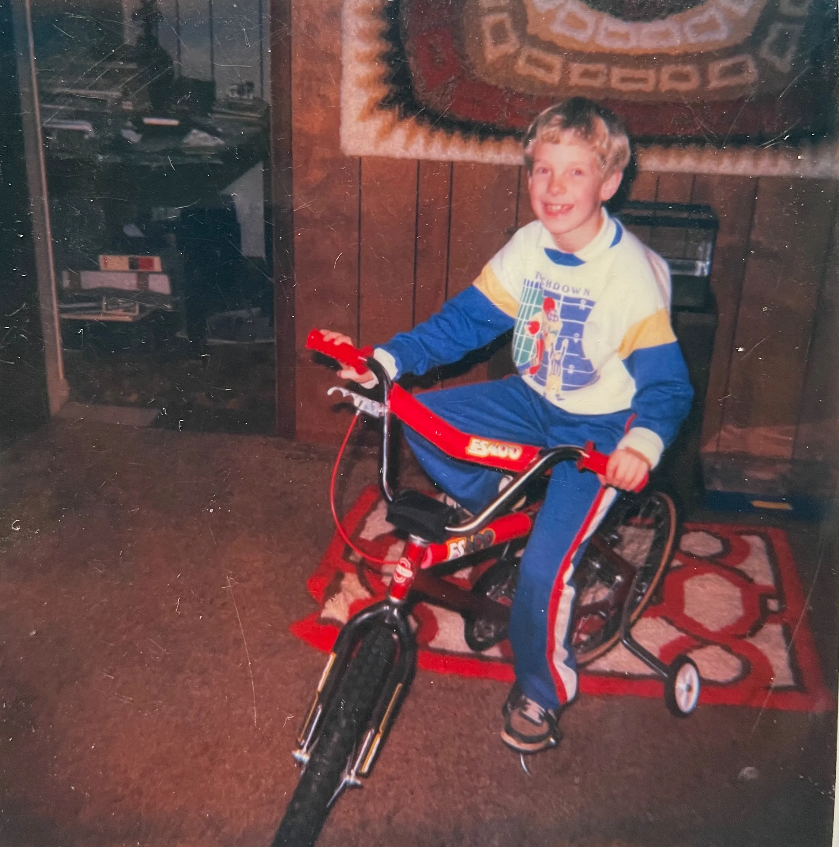 Young Chuck on a red BMX bike — Hillcrest, c. 1984–86